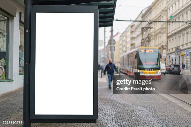 blank street-side ad lightbox with approaching tram - bus stop mockup stock pictures, royalty-free photos & images