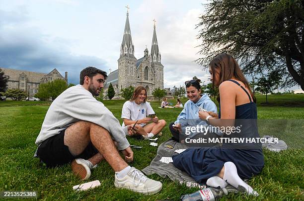 Students play cards outside of St. Thomas of Villanova Church at the campus of Villanova University in Villanova, Pennsylvania on May 8, 2025. Church...