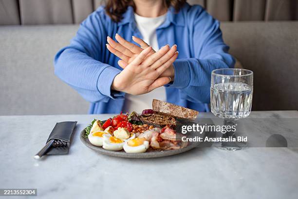 anonymous woman refuse from food.eating disorder concept. - anorexia stockfoto's en -beelden