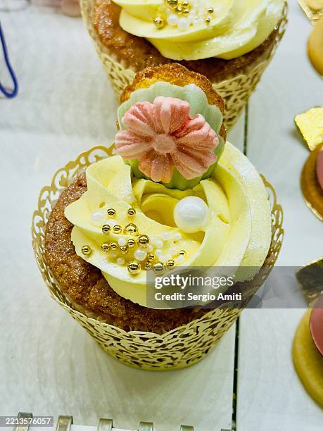 cupcake decorated with yellow buttercream - buttercream stock pictures, royalty-free photos & images