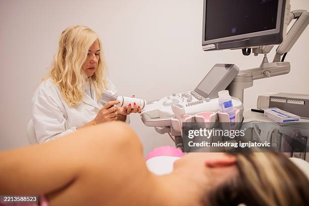 female doctor preparing to performing lymph node ultrasound on patient - diagnostic aid stock pictures, royalty-free photos & images