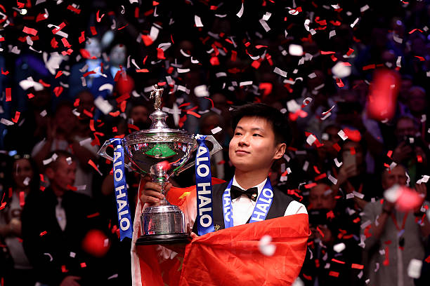 Zhao Xintong of China poses for a photo with the Halo World Snooker Championship trophy after after defeating Mark Williams of Wales in the Final...