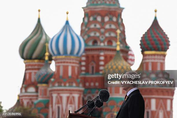 In this pool photograph distributed by the Russian state agency Sputnik, Russia's President Vladimir Putin gives a speech during the Victory Day...