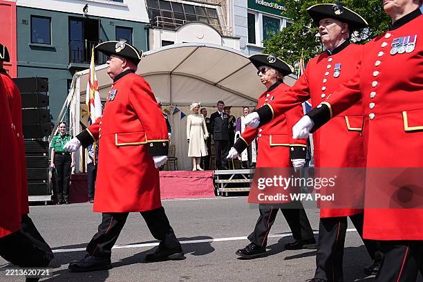 Chelsea Pensioners march past Princess Anne, Princess Royal and Vice Admiral Sir Timothy Laurence as they watch during a visit to St Peter Port, to...