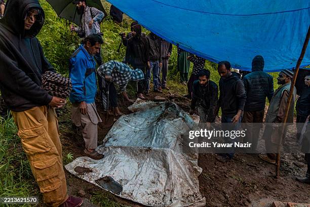 Kashmiri Muslims bury Nargis Begum, who was killed in artillery shelling allegedly carried out by Pakistani forces in the town of Uri, near the Line...