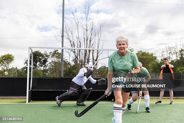 players in a field hockey team defend goal from a penalty shot - sports official stock pictures, royalty-free photos & images