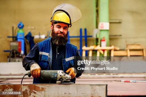 Metal worker using a grinder Metal worker using a grinder