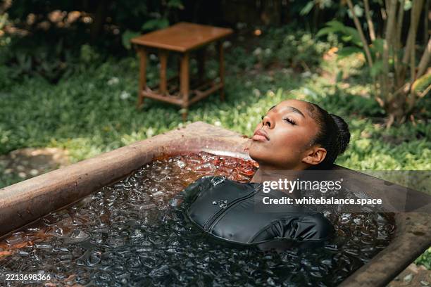 women practicing necessary steps for ice bath therapy, pinching their noses with their fingers to hold their breath - cold temperature stock pictures, royalty-free photos & images
