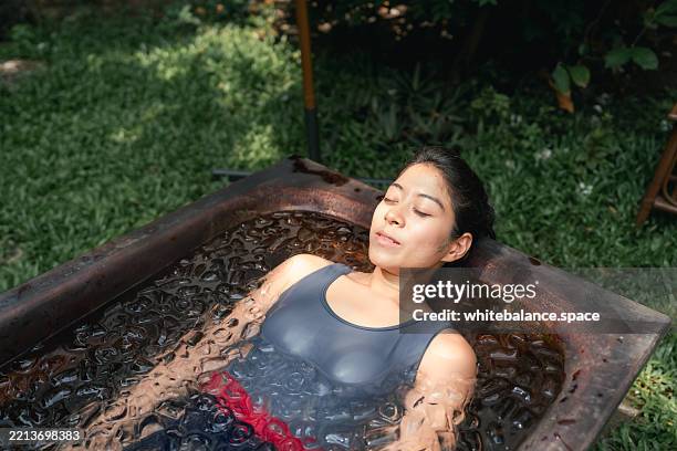 women practicing necessary steps for ice bath therapy, pinching their noses with their fingers to hold their breath - inflammation stock pictures, royalty-free photos & images