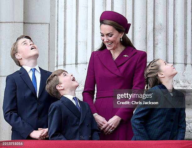 Prince George of Wales, Prince Louis of Wales, Catherine, Princess of Wales and Princess Charlotte of Wales watch the fly-past on the balcony of...