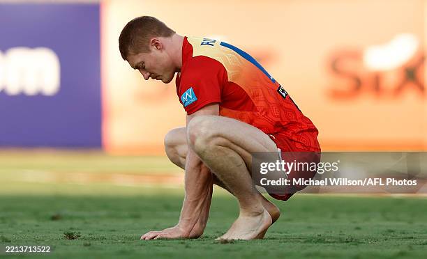 Matt Rowell of the Suns inspects the playing surface during the 2025 AFL Round 09 match between the Gold Coast Suns and the Western Bulldogs at TIO...