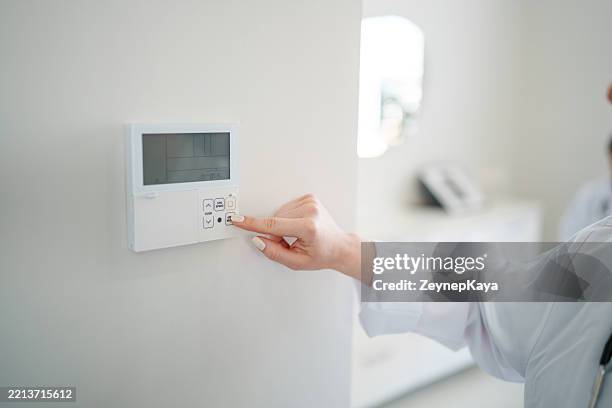 regolazione della temperatura ambiente sul pannello di controllo - termostato foto e immagini stock