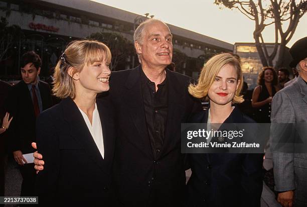 American actors Bridget Fonda and Jennifer Jason Leigh posing with director Barbet Schroeder at the premiere of 'Single White Female' at the Mann...
