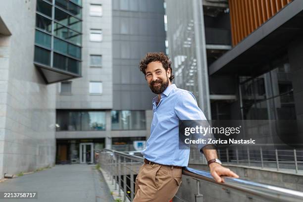 young businessman in front of office building - in front of stock pictures, royalty-free photos & images