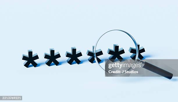 privacy under scrutiny: magnifying glass hovering over asterisk symbols in a row - asterisk stock pictures, royalty-free photos & images