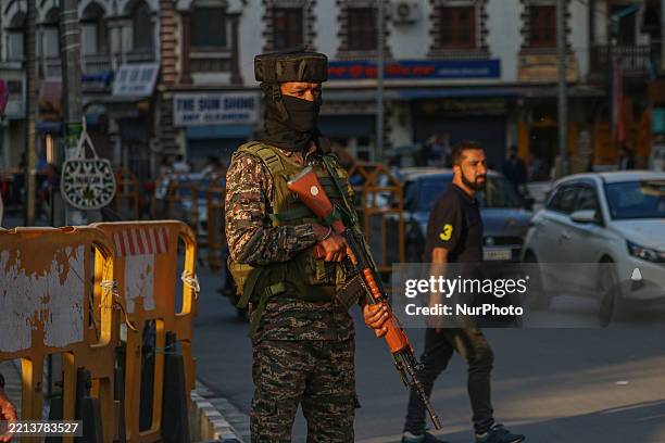 An Indian paramilitary soldier stands guard along a street after the ceasefire announcement between India and Pakistan in Srinagar, Jammu and...