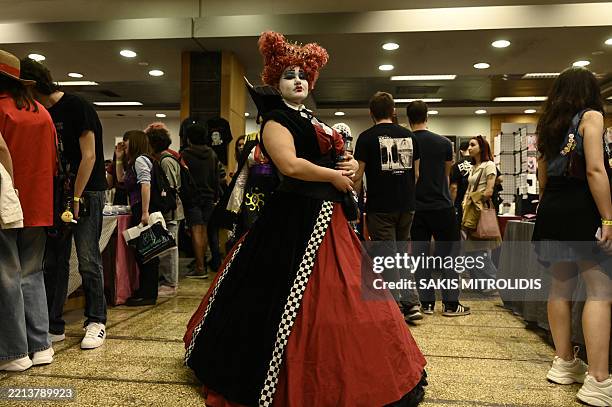 People dressed as comic book heroes pose during their visit to The Comic Con vol.9 - Thessaloniki Comic Convention, in Thessaloniki on May 10, 2025....