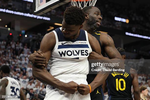 Anthony Edwards of the Minnesota Timberwolves reacts in front of Draymond Green of the Golden State Warriors during the third quarter in Game One of...