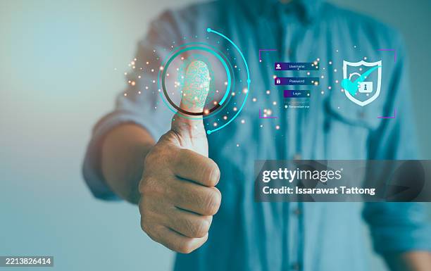 a man is giving a thumbs up to a screen that has a fingerprint on it - duim stockfoto's en -beelden