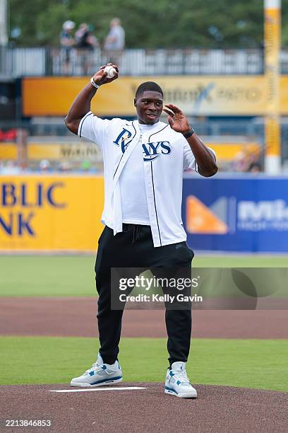 Ya Ya Diaby, linebacker for the Tampa Bay Buccaneers throws out a ceremonial first pitch before a Tampa Bay Rays game against the Milwaukee Brewers...
