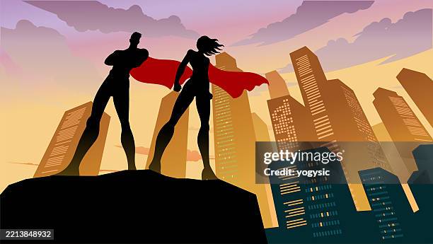 vector superhero couple silhouette standing on a cliff with city skyline background stock illustration - superhero shadow stock illustrations
