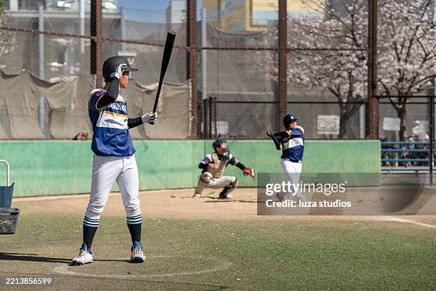 local baseball game captures players in action and team spirit - baseball team stock pictures, royalty-free photos & images