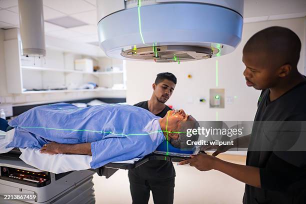 senior patient receiving cancer treatment therapy in medical oncology department - radiação imagens e fotografias de stock