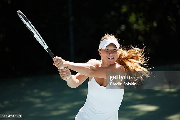 female tennis player in action - tennis racket and ball stock pictures, royalty-free photos & images