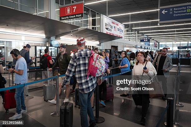 Passengers go through a security checkpoint at O'Hare International Airport on May 07, 2025 in Chicago, Illinois. As of today, air travelers must...