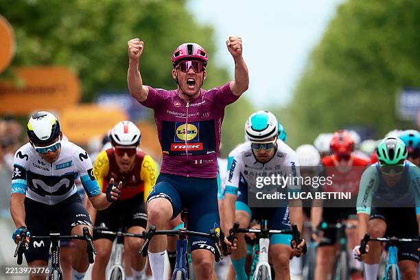 Lidl-Trek's Danish rider Mads Pedersen wearing the points classification mauve jersey celebrates as he crosses the finish line to win the 3rd stage...