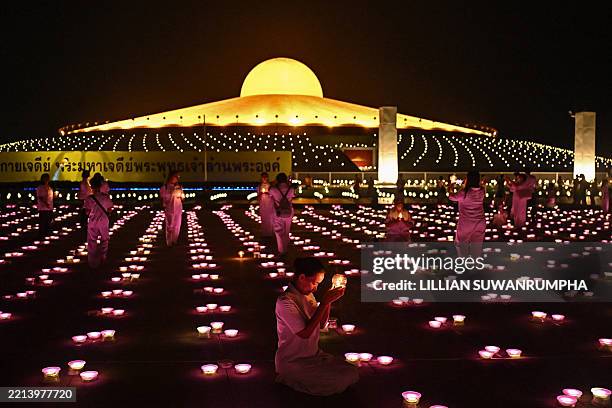 Buddhist devotees gather during the Visakha Bucha Day or Vesak Day celebrations at Wat Dhammakaya Buddhist temple in Pathum Thani province, north of...