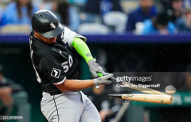 Lenyn Sosa of the Chicago White Sox breaks his bat while connecting with the ball during the fifth inning against the Kansas City Royals at Kauffman...