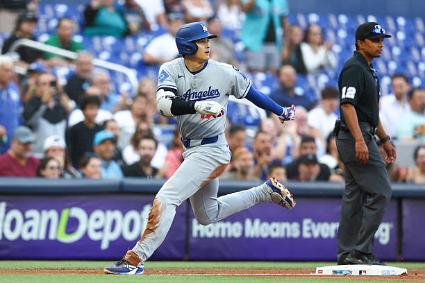 Shohei Ohtani of the Los Angeles Dodgers runs the bases after hitting a triple against the Miami Marlins in the sixth inning at loanDepot park on May...