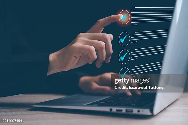 businesswoman, checklist, document, online, and desk describe this scene of a professional woman interacting with a digital form at her workstation. - list stock pictures, royalty-free photos & images