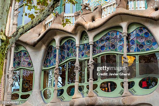 casa batlló. building designed by the architect antoni gaudí. exterior view and tree. batllo house. barcelona, catalonia, spain. - passeig de gracia stock pictures, royalty-free photos & images