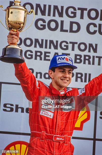 Érik Comas, DAMS, holds up the winner's trophy on the podium after Round 1 of the International F3000 Championship at Donington Park, United Kingdom,...