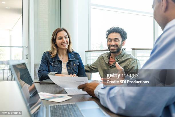 happy couple meeting with financial advisor for planning - credit union stock pictures, royalty-free photos & images