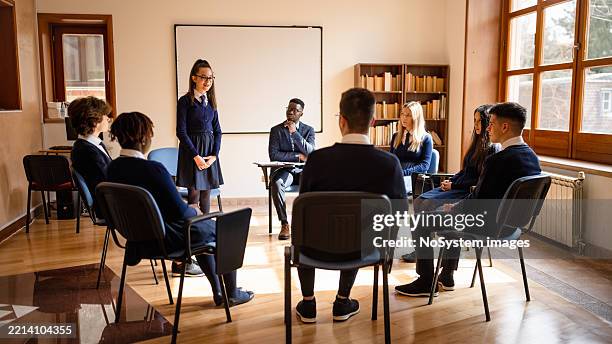 group discussion in classroom setting - debate stock pictures, royalty-free photos & images