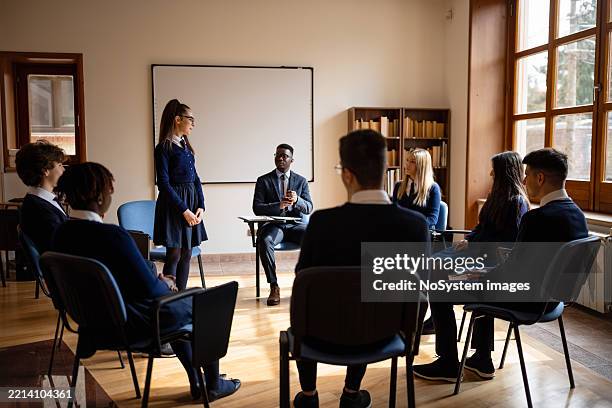 classroom presentation with teacher and students - school debate stock pictures, royalty-free photos & images