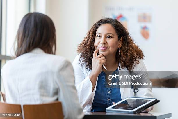 doctor and patient in discussion, healthcare consultation - neurologist stock pictures, royalty-free photos & images