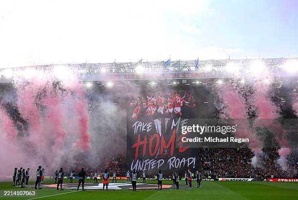 General view as fans of Manchester United display a tifo which reads "Take me home, United Road!", as a pyrotechnic display takes place prior to the...
