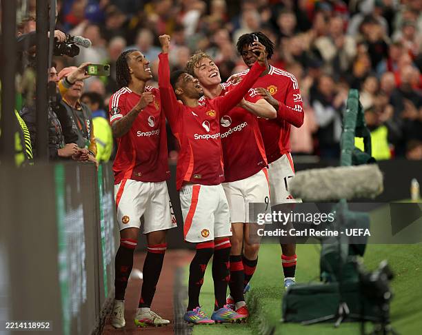 Rasmus Hojlund of Manchester United celebrates scoring his team's third goal, as teammate Amad Diallo uses a fans mobile phone during the UEFA Europa...