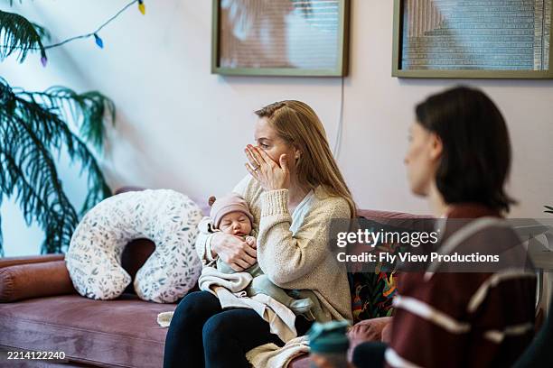 woman sharing emotional story with group of friends at postpartum support group - showing empathy stock pictures, royalty-free photos & images