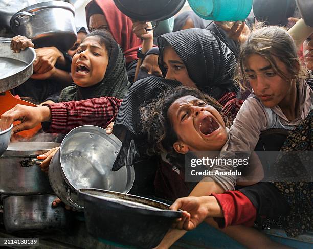 Charitable organizations distribute hot meals to Palestinians in Al-Mawasi area of Khan Yunis, Gaza on May 12, 2025. As Israel's relentless and...