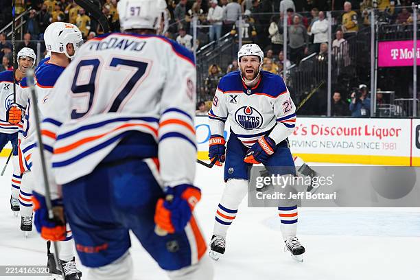 Leon Draisaitl of the Edmonton Oilers celebrates with teammates after scoring the game-winning goal to defeat the Vegas Golden Knights in overtime of...