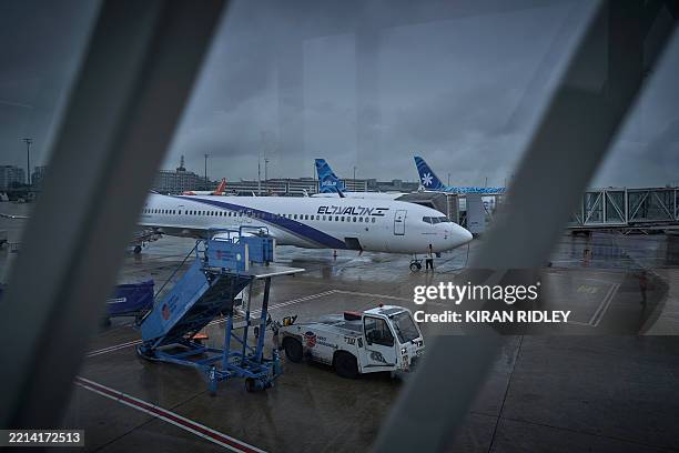 This photograph shows a plane of Israel's El Al Israel Airlines connected to an airbridge at Roissy Charles de Gaulle International airport Terminal...