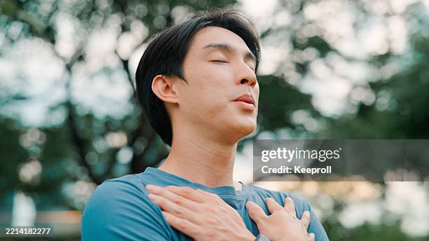 asian man breathing inhaling good air - sighing stock pictures, royalty-free photos & images
