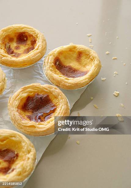 golden portuguese egg tarts on wrinkled parchment - omg stock pictures, royalty-free photos & images