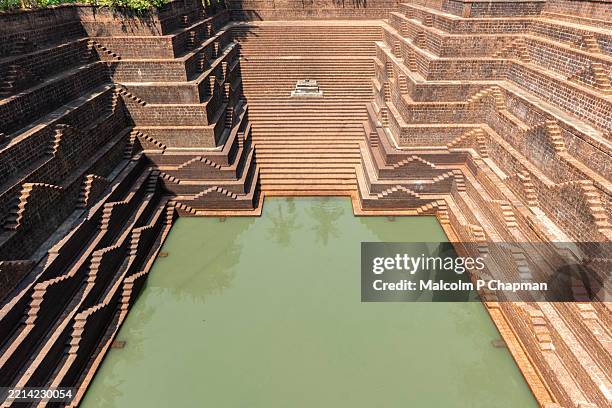 temple pond and stepwell at sri peralassery (subrahmanya) temple, kannur, india - stepwell stock pictures, royalty-free photos & images
