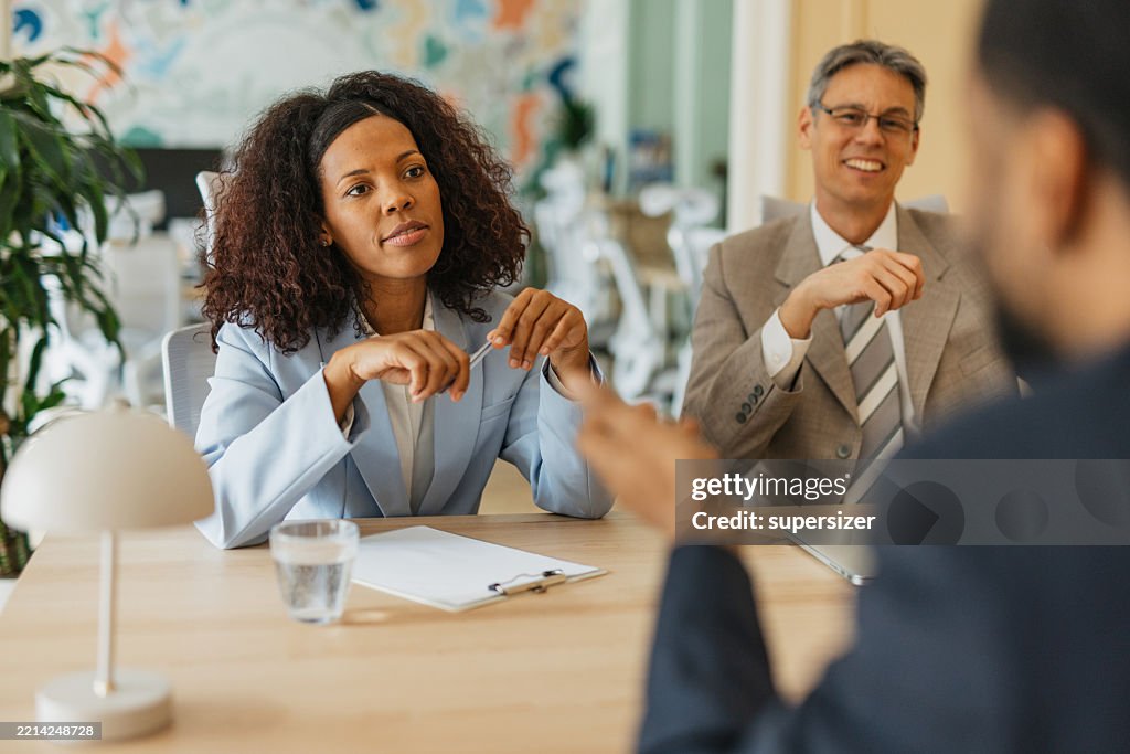 Interviewers Focused Woman Engaging With Interviewers In Office High-Res Stock Photo ...